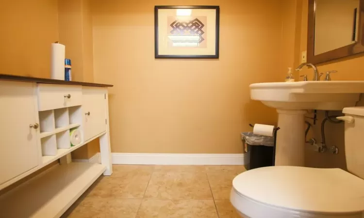 Bathroom with toilet and tile floors