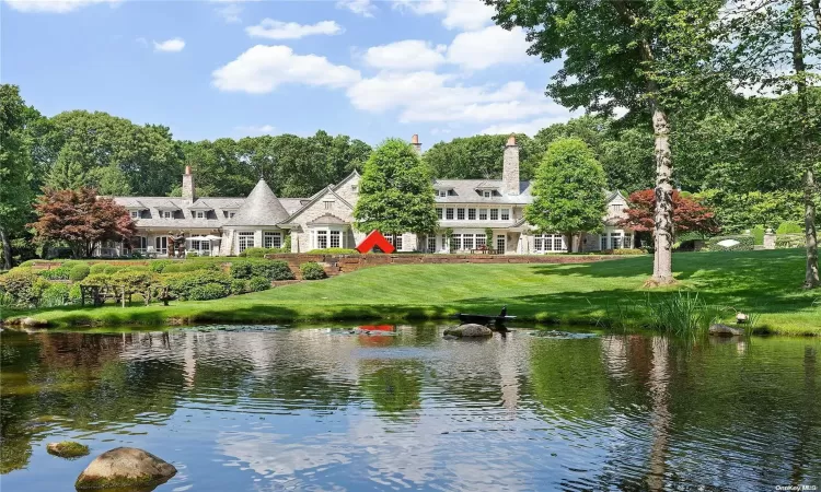 Broad Terraced Lawns Arrive at Edge of Rear Pond