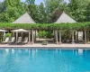 Two Cabanas with Dining Patio Set Under a Wisteria Covered Arbor