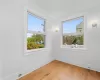 Unfurnished room with hardwood / wood-style flooring, ornamental molding, and a healthy amount of sunlight