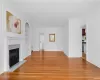 Unfurnished living room featuring a premium fireplace, crown molding, built in shelves, and light hardwood / wood-style flooring