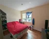 Bedroom featuring hardwood / wood-style flooring and a baseboard radiator