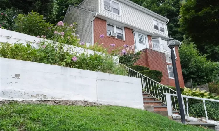 View of front of home with cooling unit