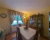 Dining room with baseboard heating and dark hardwood / wood-style floors