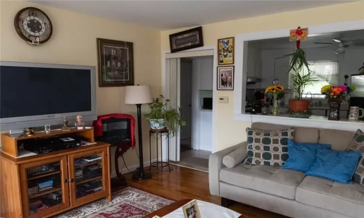 Living room with ceiling fan and wood-type flooring