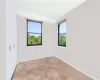 Unfurnished room featuring a wealth of natural light and light parquet floors