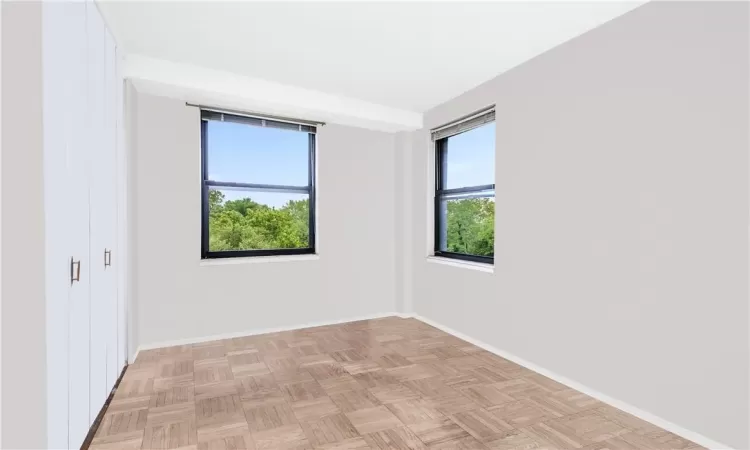 Unfurnished room featuring a wealth of natural light and light parquet floors