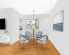 Dining room with sink, light hardwood / wood-style floors, and a chandelier