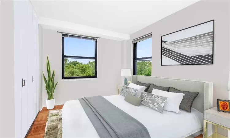 Bedroom with multiple windows and parquet floors