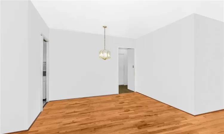 Unfurnished dining area with light hardwood / wood-style floors and a chandelier