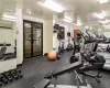 Exercise room featuring an AC wall unit