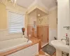 Bathroom with ornamental molding, sink, and shower with separate bathtub