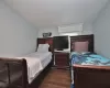 Bedroom featuring dark hardwood / wood-style flooring and vaulted ceiling