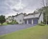 View of front property with a garage and a front lawn