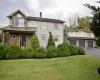 View of front of home featuring a garage and a front yard