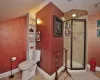 Bathroom featuring built in shelves, walk in shower, toilet, and tile patterned floors