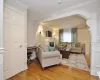 Living room with crown molding and wood-type flooring