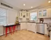 Kitchen with ornamental molding, white cabinetry, backsplash, sink, and appliances with stainless steel finishes