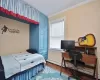 Bedroom with crown molding and hardwood / wood-style floors