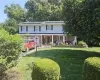 View of front facade featuring covered porch and a front yard