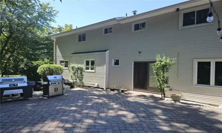 Back of house with a patio