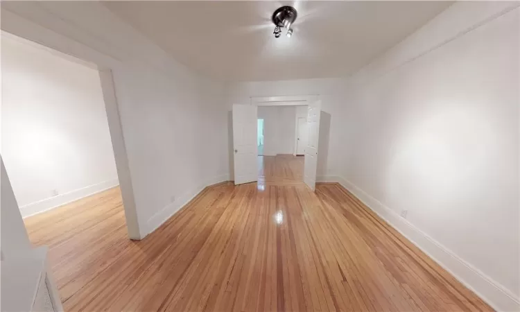 Empty room with light hardwood / wood-style floors