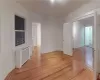 Unfurnished room featuring radiator and light wood-type flooring