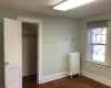 Unfurnished bedroom featuring radiator, a closet, and dark hardwood / wood-style floors