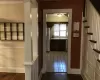 Hallway with hardwood / wood-style floors and sink