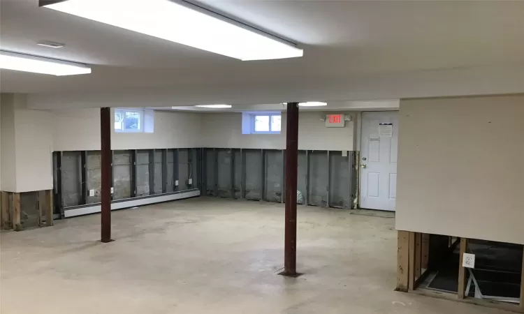 Basement with a baseboard heating unit