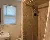 2nd fl Bathroom with curtained shower, crown molding, toilet, sink, and tile walls