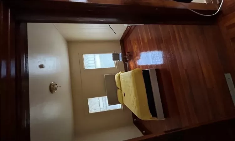 Bedroom with dark wood-type flooring