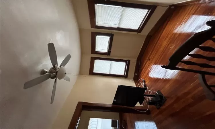 2nd Fl Unfurnished living room with ceiling fan and dark wood-type flooring