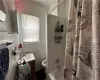 Full bathroom with vanity, tile walls, and plenty of natural light