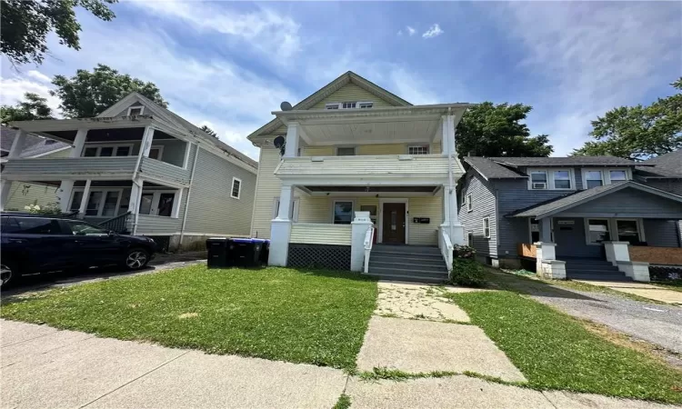 View of front of home featuring a porch and a front lawn