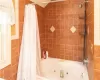 Bathroom featuring shower / bathtub combination with curtain