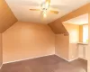 Additional living space with lofted ceiling, ceiling fan, and light tile patterned floors