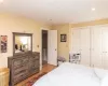 Bedroom featuring cooling unit, a closet, and light hardwood / wood-style floors