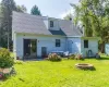 Back of house featuring a fire pit, a lawn, and a patio area