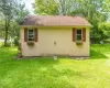 View of outdoor structure with a yard