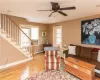 Living room featuring a baseboard radiator, ceiling fan, and light wood-type flooring