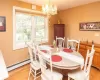 Dining space with a chandelier, baseboard heating, and light hardwood / wood-style floors