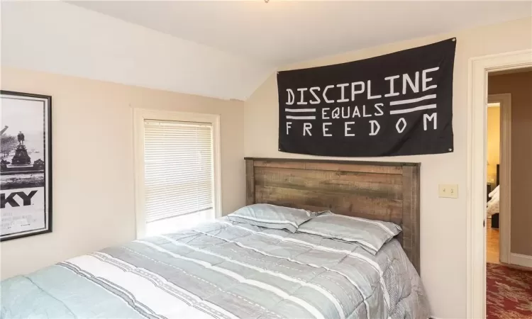 Bedroom featuring lofted ceiling