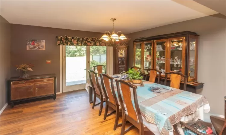 Dining area featuring wood-type flooring and a chandelier