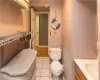 Bathroom with vanity, toilet, and tile patterned floors