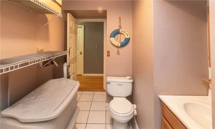 Bathroom with vanity, toilet, and tile patterned floors