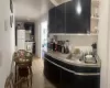 Kitchen featuring sink, light tile patterned floors, and white appliances