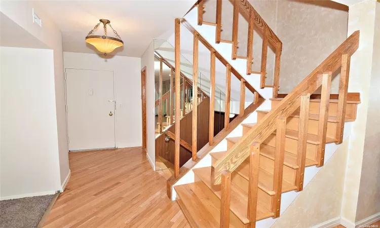 Unfurnished room featuring a baseboard radiator and hardwood / wood-style flooring