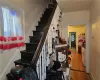 Staircase featuring ornamental molding and hardwood / wood-style floors