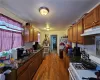 Kitchen with sink, white range with gas stovetop, and dark wood-type flooring